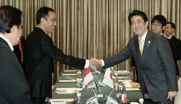 Presiden Jokowi berjabat tangan dengan Perdana Menteri Jepang Shinzo Abe saat mengikuti APEC di Beijing.