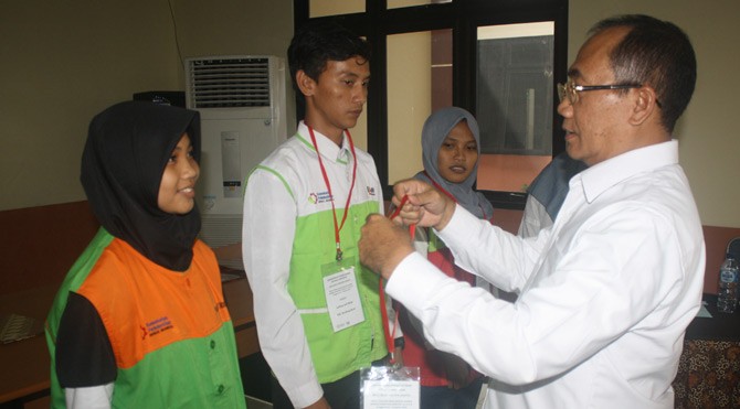TANDA PESERTA - Kepala Pusat Pendidikan dan Latihan (Pusdiklat) Industri, Kementerian Perindustrian, Mujiyono mengalungkan kartu tanda peserta kepada tiga peserta mewakili 300 peserta diklat. –tubasmedia.com/sabar hutasoit 